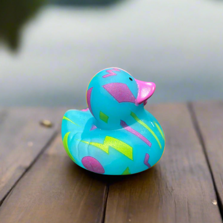 Colorful rubber duck on a wooden surface with a blurred background