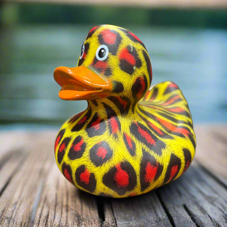 Colorful duck-shaped object with a pattern on a dark surface