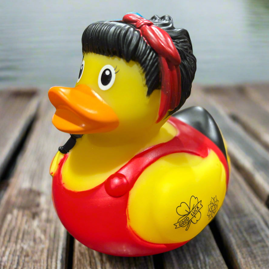 Rubber duck with a red bandana on a black surface