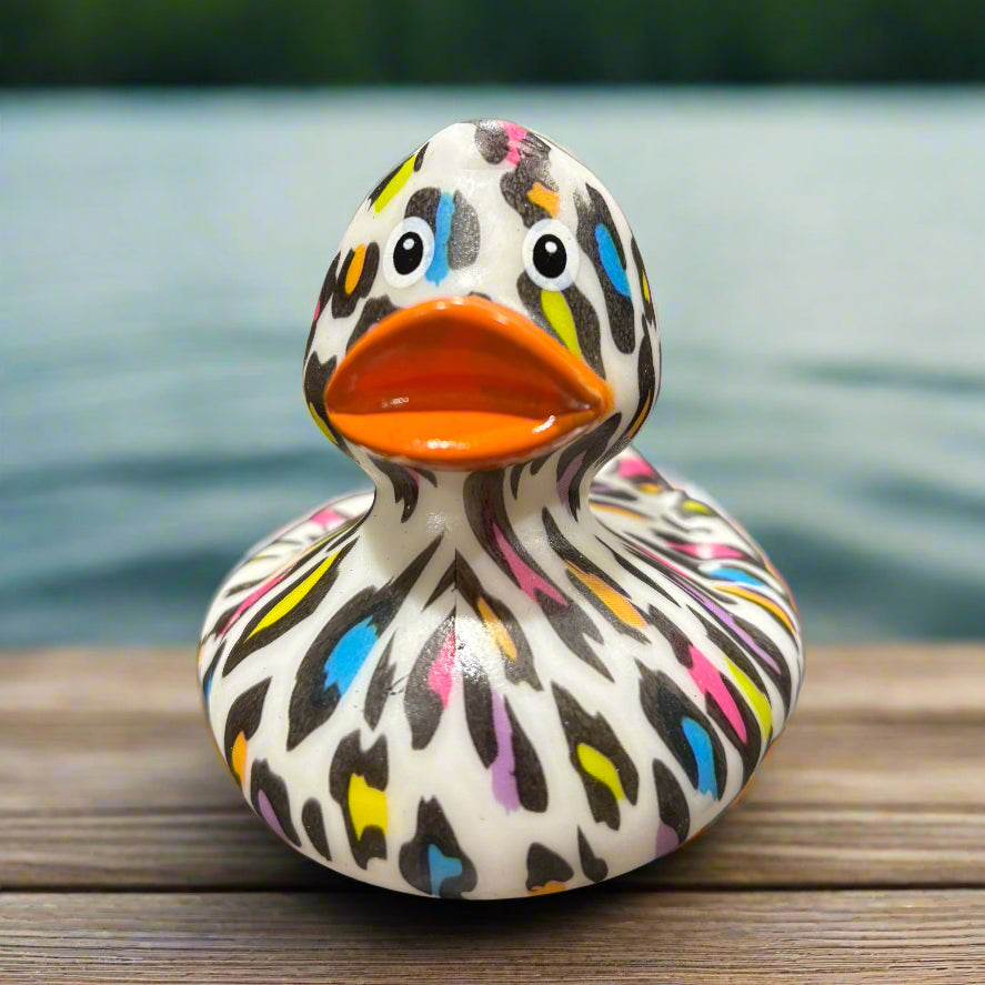 Colorful duck-shaped object on a dark surface with blurred background